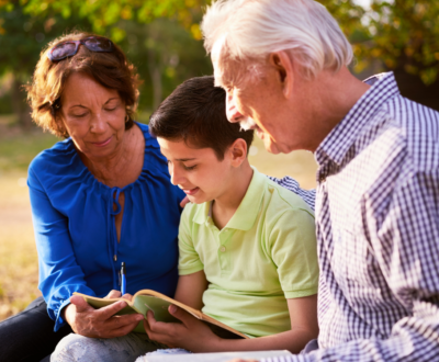 kid writing with grandparents